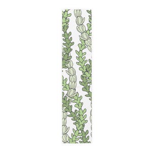 May include: A white rectangular table runner with a repeating pattern of green and light green stylized plant stems. The stems are arranged vertically, creating a botanical design. The runner is made of a soft fabric.