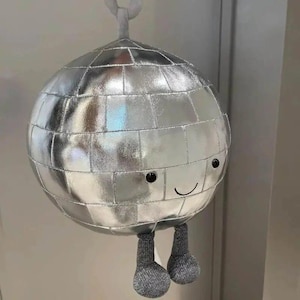 May include: A set of three ceramic mugs with a speckled, matte finish. Each mug features a different color: light blue, cream, and gray. The mugs have a simple, modern design and a comfortable handle.