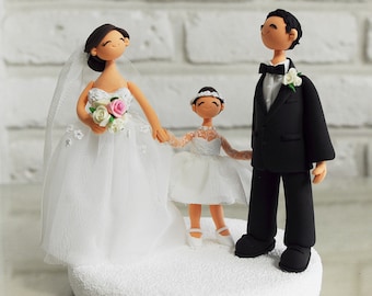 Happy couple with a daughter custom wedding cake topper