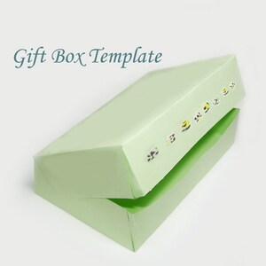 May include: A light green rectangular gift box template with the lid slightly open. The box has a row of small floral stickers along the top edge. The words "Gift Box Template" are written in a teal script font.
