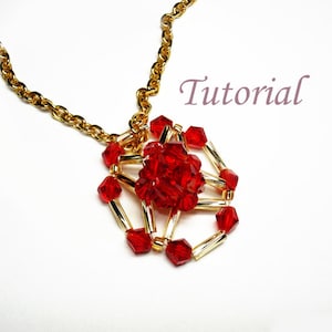 May include: A gold chain necklace with a red crystal pendant. The pendant is made of small red crystals arranged in a geometric pattern.