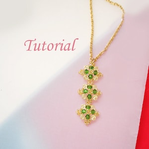 May include: A gold chain necklace with a pendant made of green and clear beads arranged in a geometric pattern. The pendant is made of three sections, each with a different design. The word "Tutorial" is written in pink lettering at the top of the image.