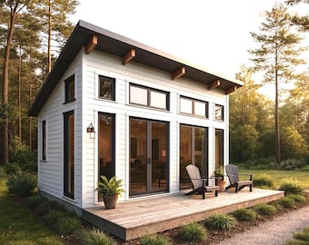 May include: A modern white cabin with a dark gray roof and wooden accents. The cabin features large glass doors and windows, a wooden deck, and two chairs. A small potted plant sits on the deck. The cabin is surrounded by trees.