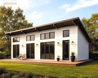 May include: Modern white house with a dark brown roof and black-framed windows and doors. The house has a wooden deck and is surrounded by green grass and landscaping. The text "KOHLHORST ARCHITECTS" is in the upper left corner.