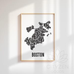 May include: Framed art print featuring a black and white map of Boston, Massachusetts. The map is composed of the names of Boston neighborhoods. The word "BOSTON" is printed in a bold font at the bottom of the print.