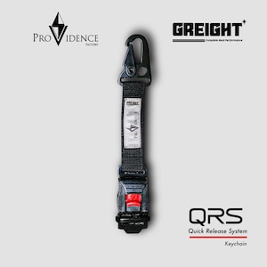 Puede incluir: Llavero negro con sistema de liberación rápida. El llavero presenta un mosquetón negro, una correa negra con una etiqueta blanca y un botón de liberación rojo. El texto "PROVIDENCE FACTORY" y "GREIGHT" son visibles.