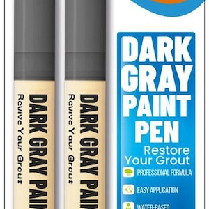May include: Two dark gray grout paint pens with the text "DARK GRAY PAINT PEN" and "Revive Your Grout". The packaging is orange and white with the brand name "GROUTASTIC". The pen is designed to restore grout.