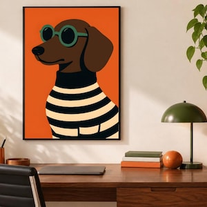 May include: A framed wall art print featuring a brown dachshund wearing round green sunglasses and a black and white horizontal striped sweater against a solid orange background. The dog is depicted in profile facing left with a black nose.