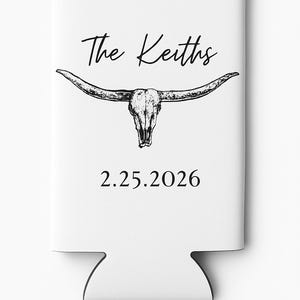 May include: White can cooler featuring a black illustration of a longhorn skull. The text "The Keiths" is above the skull, and the date "2.25.2026" is below. The cooler has a cutout at the bottom.