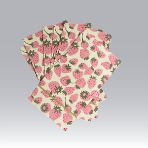 a set of paper hostess napkins with a cream background with pink strawberries w gold accents against a light gray background.  Mother's day gift table accent.  
Https://swirlingorange11.com