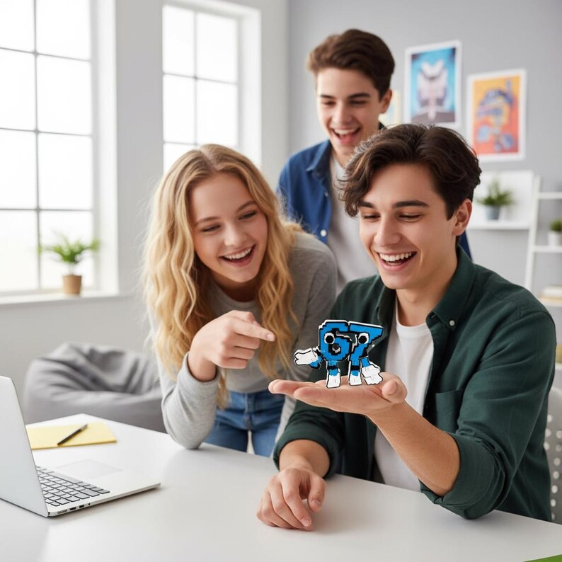 May include: Three young people are smiling and looking at a blue and white figure of the number 57. The figure is held in the palm of a person's hand. A laptop is on the table in front of them.