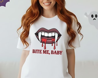 May include: White t-shirt with a vampire mouth graphic and the text "BITE ME, BABY" in red. The design features a mouth with sharp fangs and dripping blood. Halloween-themed apparel.
