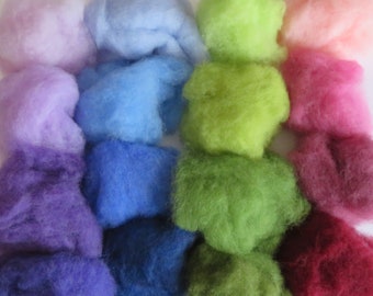 May include: A collection of colorful wool roving in various shades of purple, blue, green, pink, and red. The wool is arranged in rows, with each row featuring a different color.