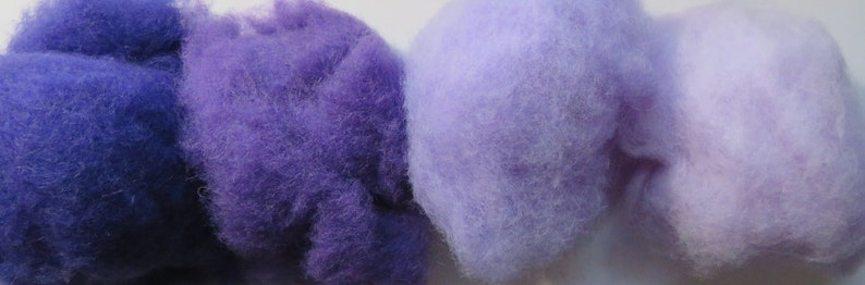 May include: Four balls of wool yarn in shades of purple, blue, and lavender. The yarn is soft and fluffy, and it would be perfect for knitting or crocheting.