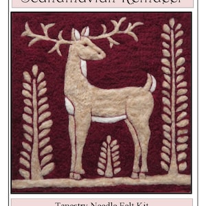May include: A needle felting kit featuring a Scandinavian Reindeer design. The kit includes all the materials and instructions needed to create a felt tapestry of a reindeer standing in a forest setting. The reindeer is beige with white accents, and the forest is depicted with green trees.