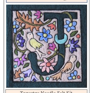 May include: A needle felting kit featuring a floral monogram of the letter "J" in a green frame. The design includes birds, flowers, and leaves in shades of pink, blue, yellow, and green. The kit is titled "Florentine Monogram" and "Tapestry Needle Felt Kit".