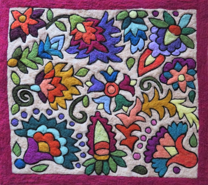May include: A colorful felt wall hanging with a floral design. The flowers are in shades of red, orange, yellow, green, blue, and purple. The background is a light beige color and the border is a deep pink.