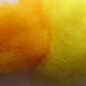 May include: Four samples of wool yarn in shades of yellow, orange, and brown. The yarn is fluffy and soft.