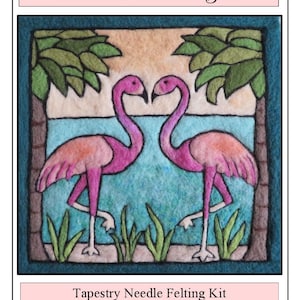 May include: Needle felting kit featuring two pink flamingos standing in a blue lagoon with palm trees. The kit includes instructions and materials. "Florida Flamingos" is written at the top of the image. "Tapestry Needle Felting Kit" and "Instructions & Materials Included" are written at the bottom of the image. www.thefeltingstudio.com is also included.