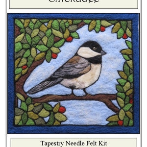 May include: A needle felting kit featuring a chickadee perched on a branch with red berries. The kit includes instructions and materials. "Chickadee" and "Tapestry Needle Felt Kit" are written on the image.