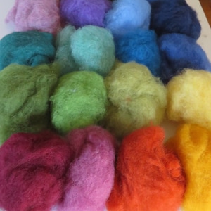 May include: A collection of 16 balls of wool in various colors, including pink, green, blue, yellow, and red.