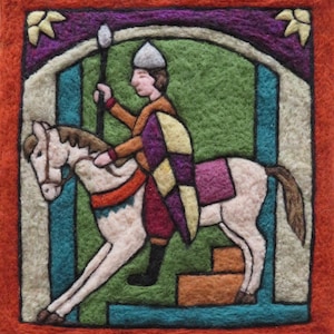 May include: A felted artwork depicting a medieval knight on horseback. The knight wears a helmet, tunic, and a shield with a checkered pattern. The horse is white, and the background features an archway and a green field, all framed by an orange border.