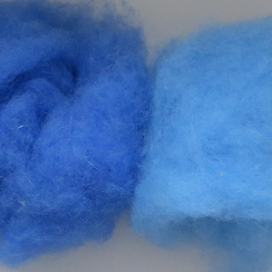May include: Four samples of blue wool fiber, ranging in shade from dark blue to light blue.