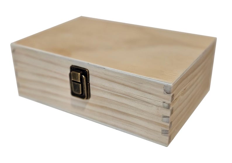 May include: A rectangular wooden box with a light brown finish. The box has a hinged lid and a metal clasp closure. The wood grain is visible, and the box appears to be new.