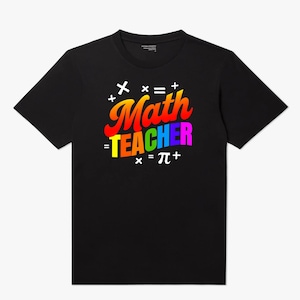 May include: Black t-shirt with a colorful graphic that reads "Math TEACHER" in a rainbow gradient font. The design includes mathematical symbols such as plus signs, equal signs, and pi. A fun and educational apparel item.