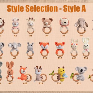 May include: A collection of twenty-two crochet baby rattles in various animal designs, including a lion, giraffe, bear, elephant, fox, bunny, and bee. Each rattle features a wooden ring for easy gripping. The text "Style Selection - Style A" is at the top.