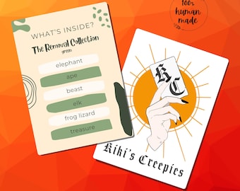 May include: Two cards with text and illustrations. One card reads "WHAT'S INSIDE? The Removal Collection green" with a list of words. The other card shows a hand holding a card with the text "KC" and "Kiki's Creepies". A circular design reads "100% human made".