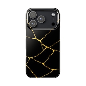 May include: Black smartphone case with a glossy finish, featuring a gold crack pattern design. The case has a clear border and a camera module with three lenses.