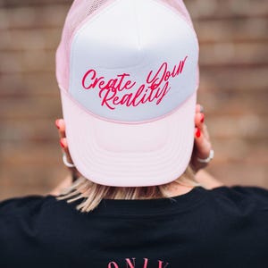 Create Your Reality Trucker Hat- Manifestation DTF Printed Cap- Pink and White Mesh Hat- Inspirational Quote Trucker Hat