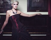 Red and black lace corset and full length skirt.
