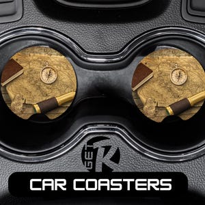 May include: Car coasters with a vintage map design. Each coaster features a compass, a book, and a pen. The coasters are round and fit into a car's cup holders. The text "CAR COASTERS" is displayed on a black background.