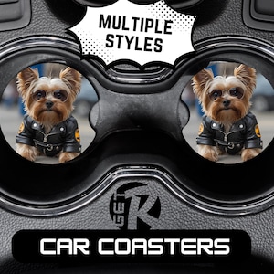 May include: Black car coasters featuring a Yorkshire Terrier wearing sunglasses and a black leather jacket. The coasters are set in a car cup holder. The text "MULTIPLE STYLES" and "CAR COASTERS" are also visible.