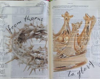 May include: An open book with printed text featuring a translucent overlay. The left page shows a crown of thorns with the handwritten text 'from thorns'. The right page displays a golden crown illustration with the handwritten text 'to glory'.