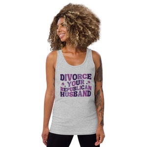 May include: A gray tank top with the text "DIVORCE YOUR REPUBLICAN HUSBAND" in purple and pink lettering with glitter accents.