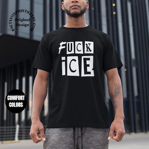 May include: Black t-shirt with the words "FUCK ICE" in white block letters. The shirt is a crew neck style and appears to be made of a soft material. The image also includes the text "COMFORT COLORS" in a circle.