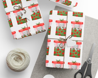May include: Wrapped gifts with a repeating pattern of a gray elephant peeking out of a red-topped gift box on a white background. The gifts are tied with twine and a white tag. A ball of twine, scissors, and tags are also present.