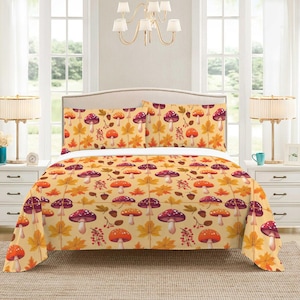 May include: A bed set featuring a repeating pattern of mushrooms, maple leaves, and berries in shades of orange, red, and purple on a cream background. The set includes a comforter and two pillowcases, creating a cozy autumn theme.