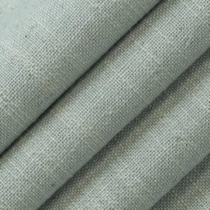 May include: Close-up of folded, light gray linen fabric. The fabric has a textured weave, with visible threads creating a subtle pattern. The folds create shadows and highlights, adding depth to the image. Ideal for home decor or apparel.
