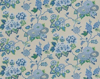 May include: Floral pattern featuring blue and light blue flowers with green leaves and stems on a cream background. The design includes various sizes of blossoms and buds, creating a repeating pattern.