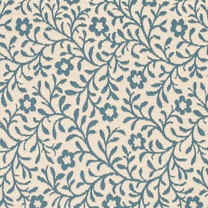 May include: A close-up of a cream-colored fabric with a repeating pattern of blue floral vines and flowers. The design is detailed and intricate, creating a textured appearance. The overall aesthetic is reminiscent of a classic, vintage style.