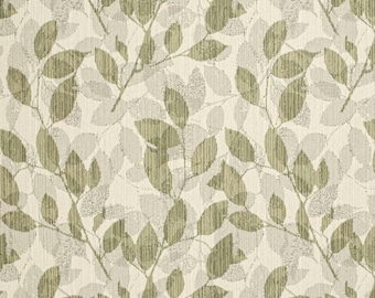 May include: A fabric with a repeating pattern of stylized leaves and branches in shades of green and gray against a cream-colored background. The leaves have a textured appearance, creating a natural, organic feel. The design is suitable for home decor.