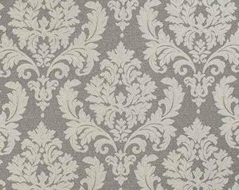 May include: A seamless pattern featuring a classic damask design. The pattern showcases a repeating motif of ornate, off-white floral elements set against a textured gray background. The design is symmetrical and detailed, suitable for various decorative applications.