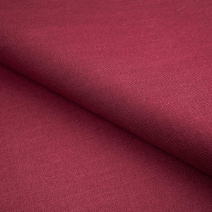 May include: Close-up of a folded section of deep red fabric. The material has a textured appearance, with visible woven threads. The color is a rich, saturated shade of red, with subtle variations in tone across the surface. The fabric appears to be a medium-weight material.