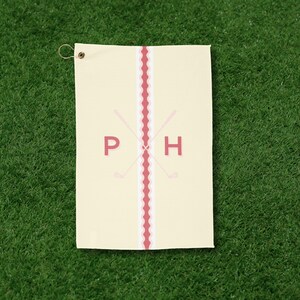 Personalized golf towel with custom monogram lettering and minimalist golf club design, shown at a golf course. This embroidered-style golf cart towel is ideal for golf tournaments, bachelor parties, Father’s Day gifts, and stylish golf accessories.