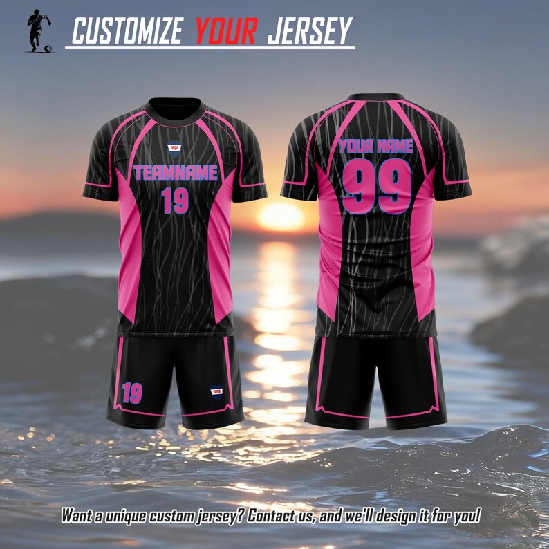 May include: A black and pink soccer jersey and shorts set featuring the text CUSTOMIZE YOUR JERSEY at the top. The jersey displays TEAMNAME 19 on the front and YOUR NAME 99 on the back. The shorts feature the number 19 in pink text.
