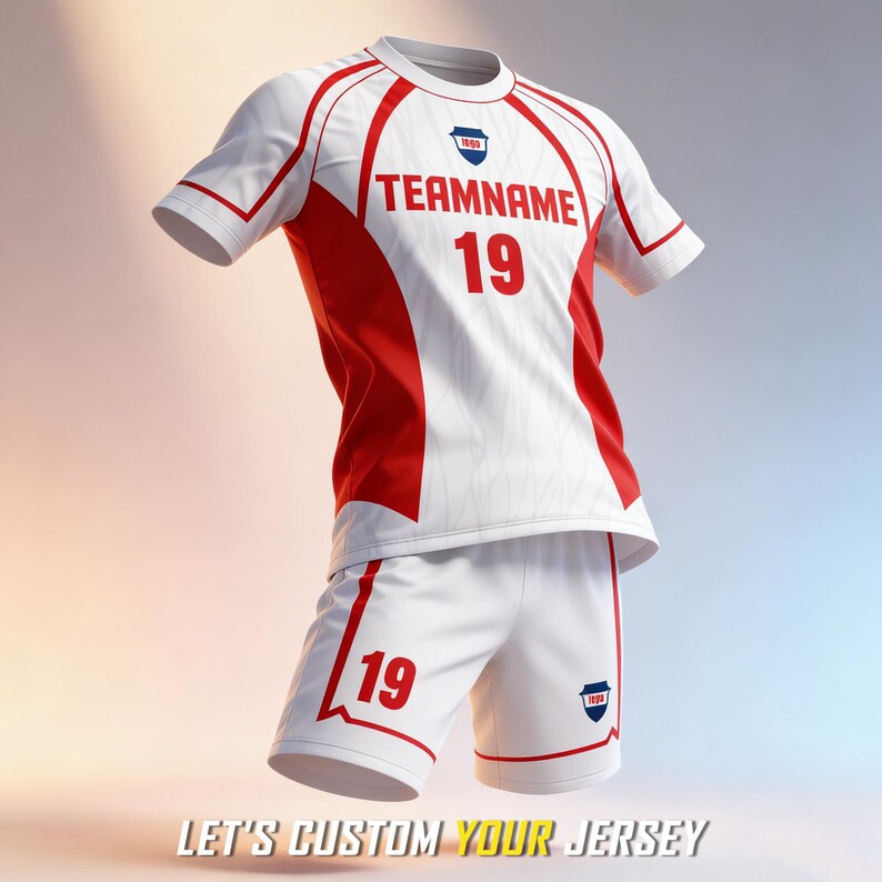 May include: A white and red sports jersey and shorts set featuring the text TEAMNAME and the number 19 in red on the chest and shorts. The jersey has a round neckline, short sleeves, and a small shield-shaped logo on the chest and shorts.